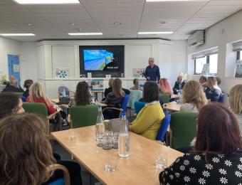 Conference Room in The Deep Business Centre filled with a seated audience, listening into a presentation being delivered.