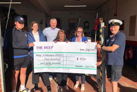 The Deep Business Centre team presenting a cheque of £450 to the crew members from Withernsea RNLI